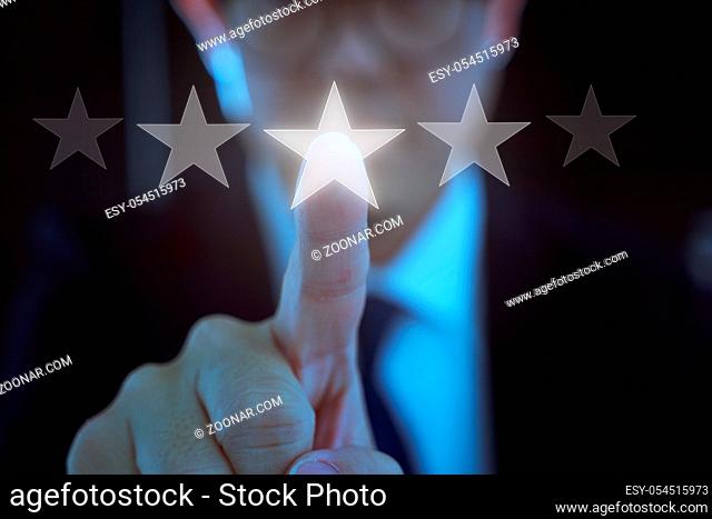 Young businessman touch the five star symbol to increase rating of company