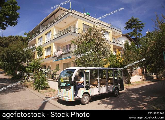 New vehicle-minibus of the Municipality of the Princes's Islands used instead of the horse carts for the public transport in front of the old wooden houses in...