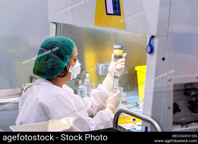 Mature pharmacist making medicines in laboratory at hospital