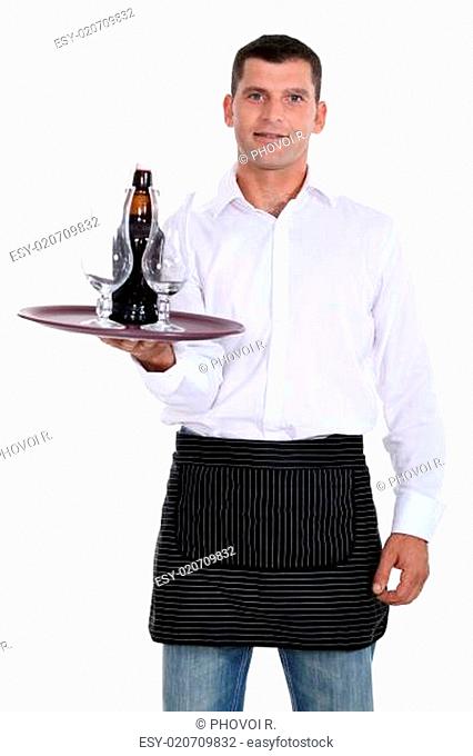 waiter holding tray with glasses and bottle
