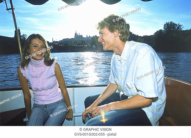 Young couple sitting together on a boat