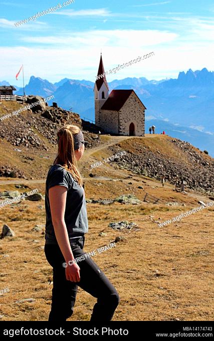 young woman, hike, Latzfons, Klausen, Bolzano Province, South Tyrol, Italy, Europe. The refuge and the Latzfonser Kreuz pilgrimage church