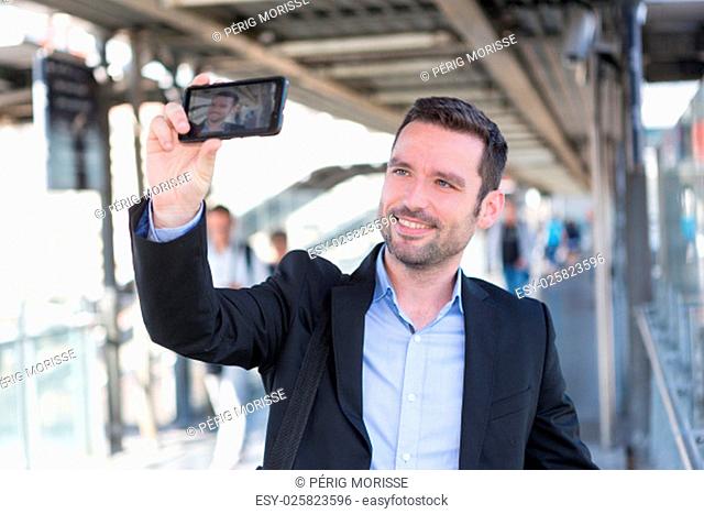 View of a Young attractive businessman taking some selfies