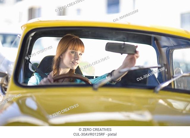 red haired Woman driving a car