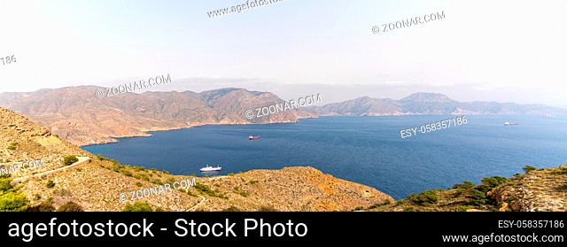 A view of the Sierra de Muela mountains and the Bay of Cartagena in Murcia with moored freight ships at anchor