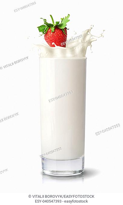 Strawberry falling into milk. Glass of milk isolated on white background. Splash of milk