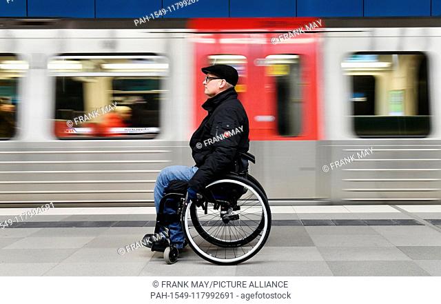 A Wheelchair user at an underground station, Germany, city of Hamburg, 05. March 2019. Photo: Frank May (model released) | usage worldwide