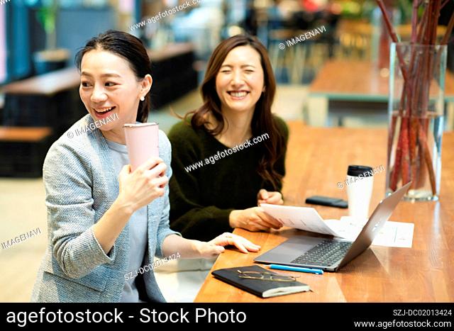 Two women in coworking office