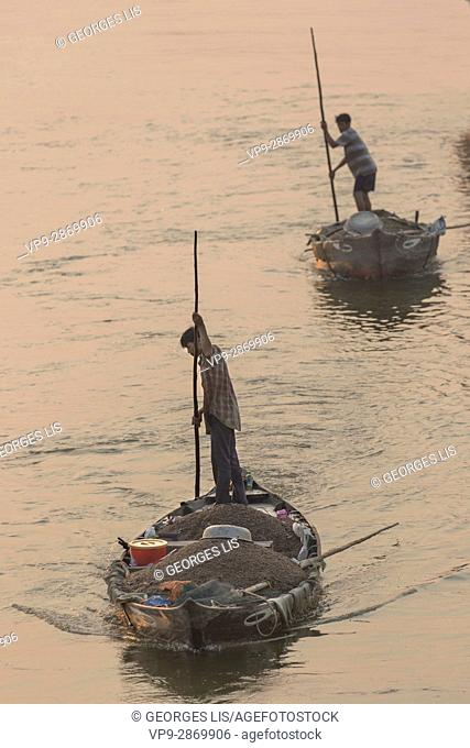 fisher on his boat on Thu Bon river Hoi An Vietnam