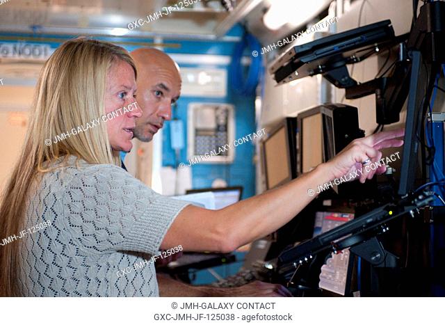 NASA astronaut Karen Nyberg and European Space Agency astronaut Luca Parmitano, both Expedition 3637 flight engineers, participate in an electrical power system...