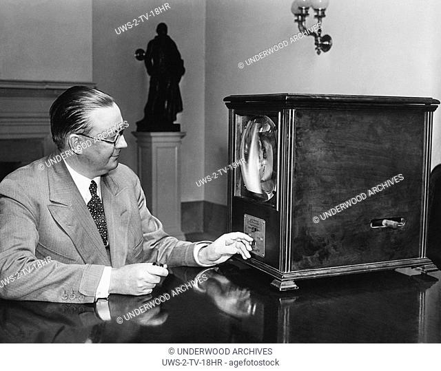 Washington, D.C.: July 8, 1931.George Hastings, Secretary to President Herbert Hoover, examines a television receiver in his office at the White House