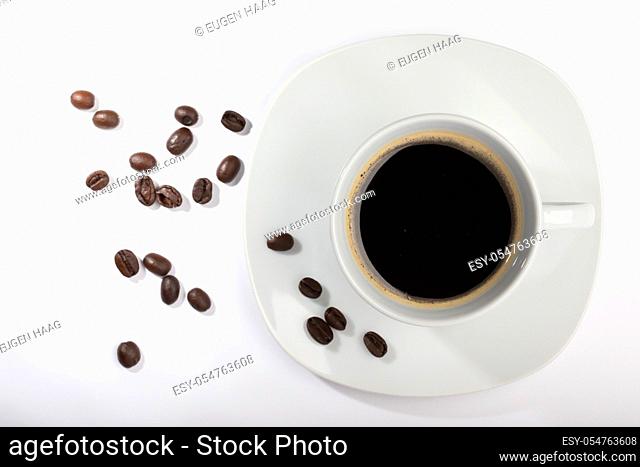 A White cup with coffee on a white background and coffee beans