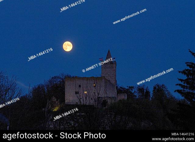 Full moon rising behind Saaleck Castle and Rudelsburg in Thuringia