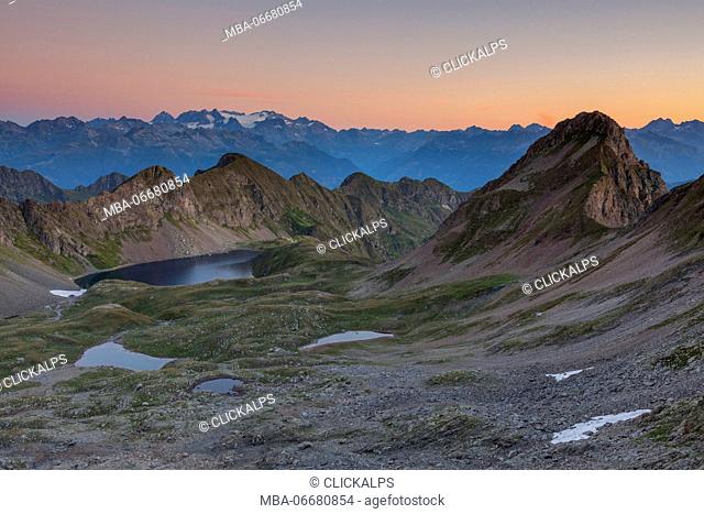 Bivouac Davide, St. Anthony valleys, Orobie regional park, Lombardy, Italy. View from Torsoleto pass to Bernina group at sunrise