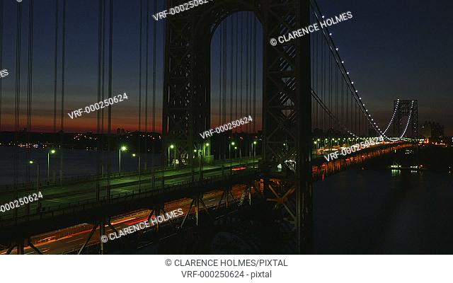 (Time-lapse) Morning rush hour traffic on the George Washington Bridge crosses the Hudson River between New Jersey and New York just before sunrise