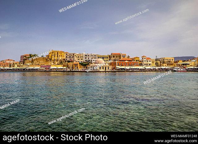 Greece, Crete, Chania, Harbor of coastal city with Kucuk Hasan Pasha Mosque in background