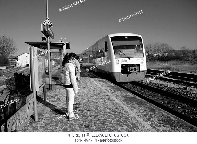 A Young Girl waiting for the Train in a Wintermorning