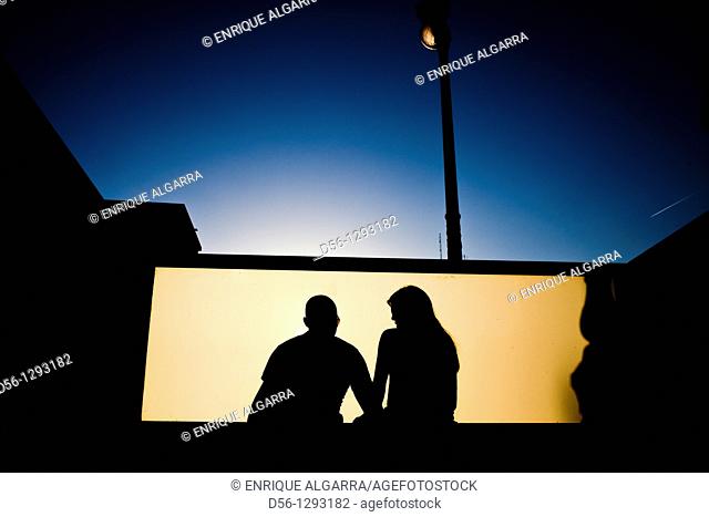 couple seated at a metro station, Valencia, Spain