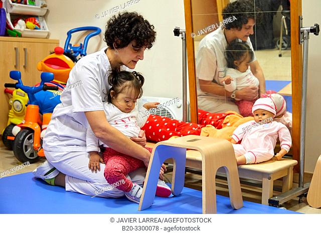 Physiotherapist teaching a girl with Down syndrome to stand up, Rehabilitation, Amara Berri Health Center building, Donostia, San Sebastian, Gipuzkoa
