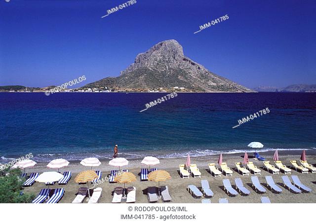 Dodecanese, Kalymnos View of Telendos from Masouri beach, umbrellas, deck chairs