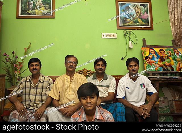 Raju Kumar Das, best known as RK Das, one of the first generation rickshaw artists in Bangladesh, poses to be photographerd along with his sons and grandson at...