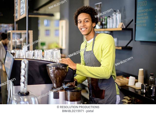Mixed race barista working in coffee shop