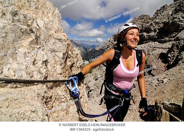 Climber, woman, on fixed rope route onto Paterno, Alta Pusteria, Sexten Dolomites, South Tyrol, Italy, Europe