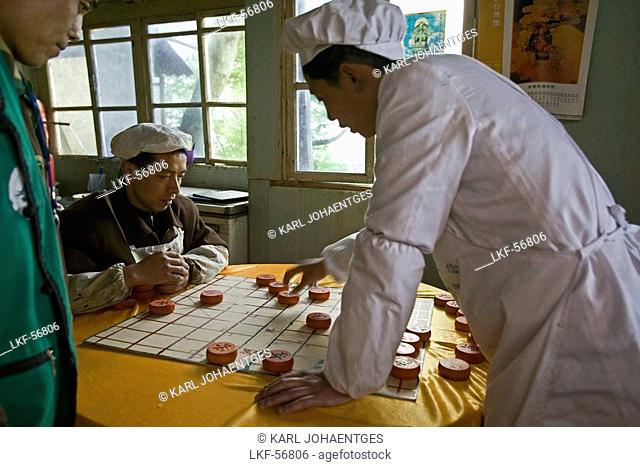 kitchen staff of a small restaurant next to the path play chinese Chess, Emei Shan Mountains, China, Asia, World Heritage Site, UNESCO