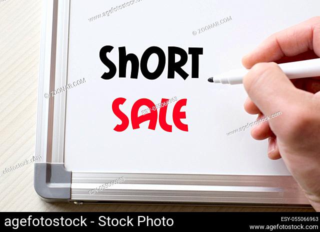 Human hand writing short sale on whiteboard