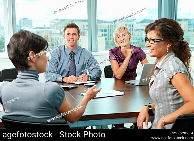 Group of young business people talking on business meeting at office
