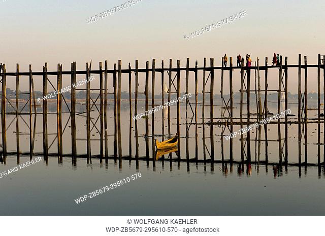 U Bein Bridge (built around 1850 and is believed to be the oldest and longest teakwood bridge in the world) reflecting in Taungthaman Lake near Amarapura