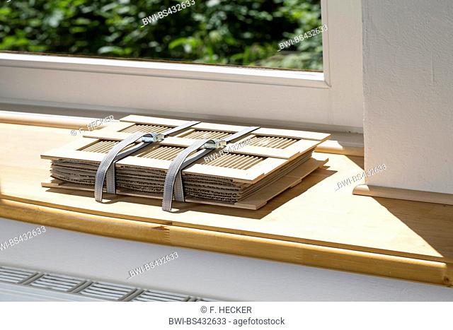herbarium press lying in the sun on a window sill over the heater, Germany