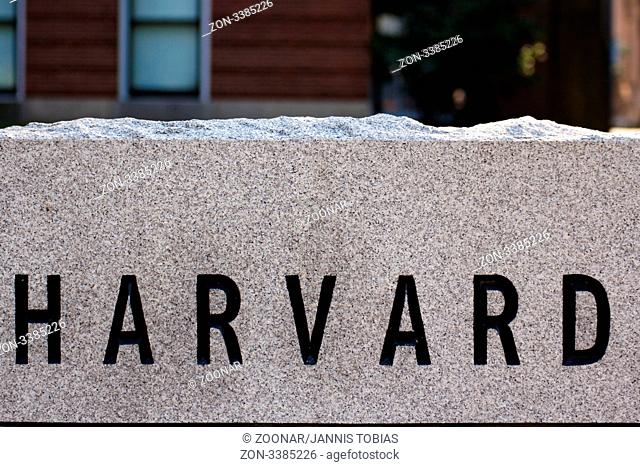Detail of a granite marker in a driveway at Harvard University campus in Cambridge, MA, showing the letters HARVARD chiselled into the stone