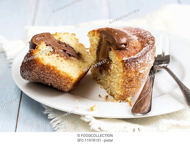 A doughnut muffin filled with chocolate cream, sliced