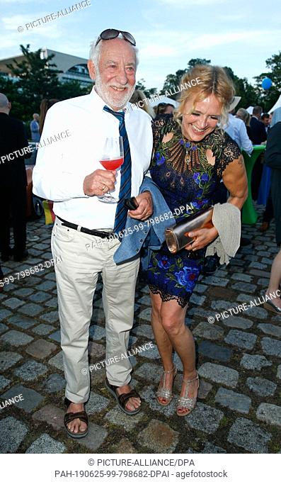 25 June 2019, Berlin: Dieter Hallervorden and his girlfriend Christiane Zander laugh at the producer festival of the Allianz Deutscher Produzenten - Film und...