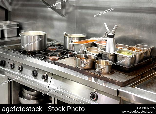 Stainless steel restaurant professional kitchen equipment and work surface. High quality photo