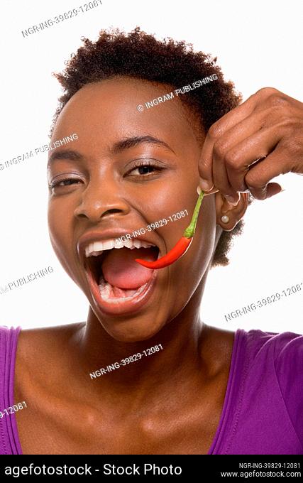 Woman eating chili pepper