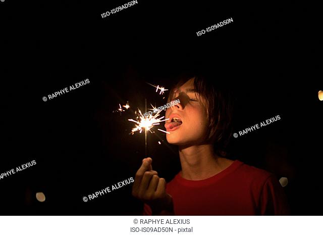 Portrait of boy holding sparkler on independence day, Destin, Florida, USA