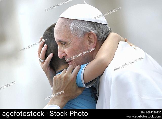March 13, 2023 marks 10 years of Pontificate for Pope Francis. in the picture : Pope Francis kisses a child from at the end of a canonisation mass