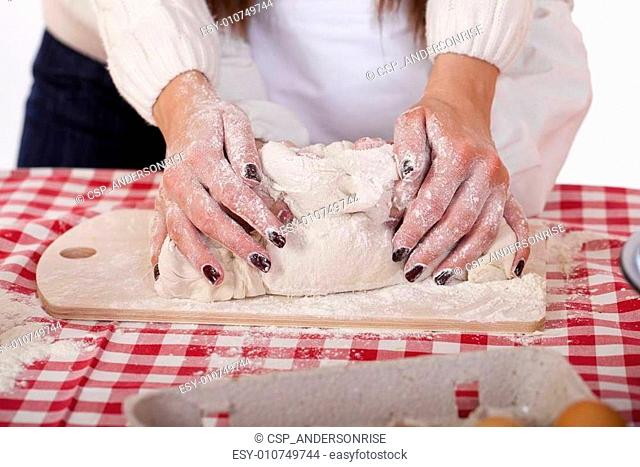 Close up hands of family are baking cakes in home kitchen