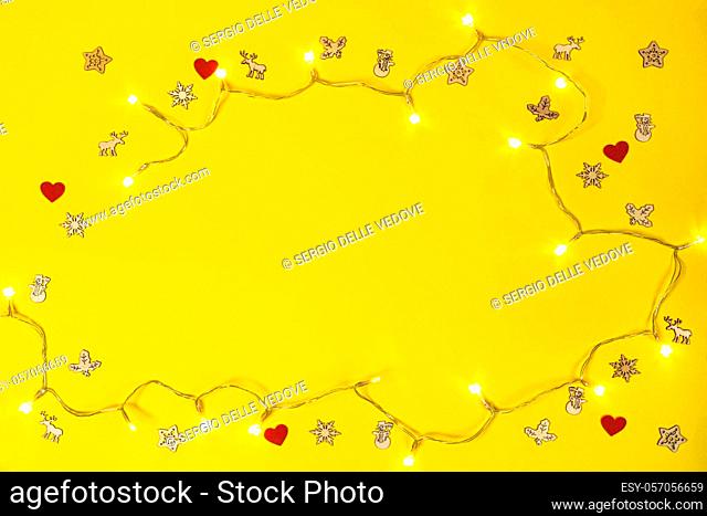 some small decorative icons and holiday lights on a yellow background