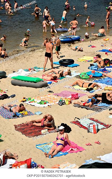 People enjoy a hot sunny day at the outdoor swimming pool Sloup v Cechach, Northern Bohemia, Czech Republic, on Saturday, July 4, 2015