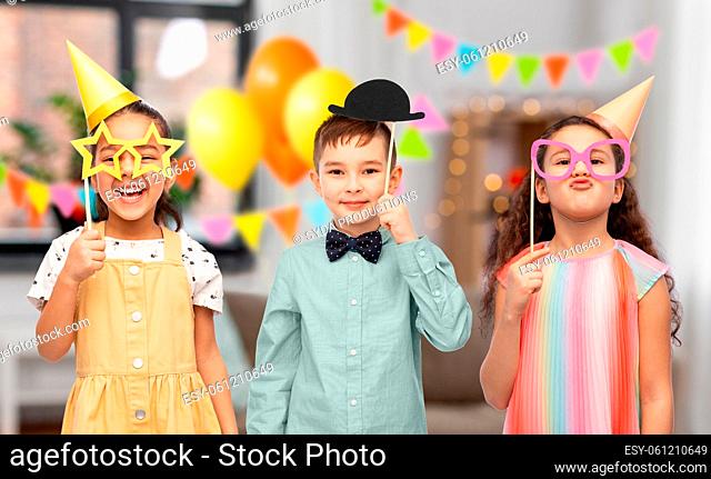 happy children with glasses on home birthday party