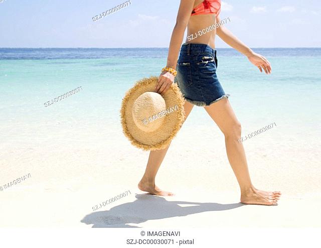 Woman walking along beach