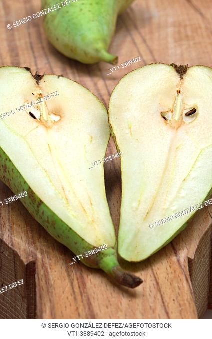 pear split in two on wood board for backgrounds and textures