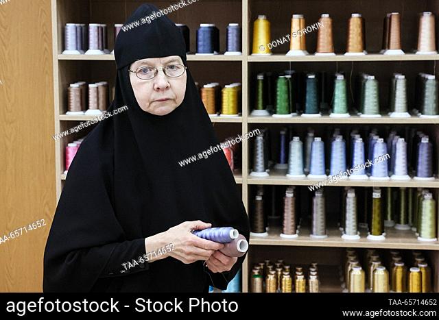 RUSSIA, YEKATERINBURG - DECEMBER 13, 2023: A nun picks spools of thread to make Christmas decorations at a sewing workshop of Alexander Nevsky Novo-Tikhvinsky...
