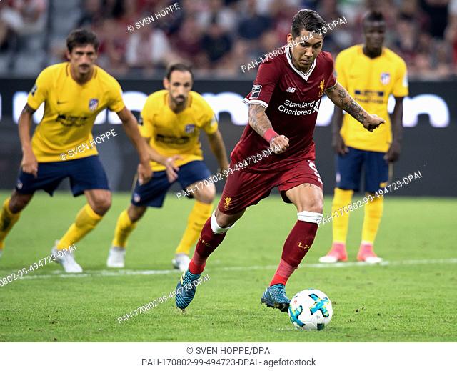 Liverpool's Roberto Firmino converts a penalty kick to level the score at 1:1 during the Audi Cup final soccer match between Atletico Madrid and FC Liverpool in...