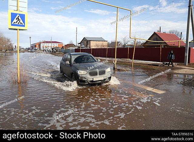 RUSSIA, SAMARA REGION - MARCH 16, 2023: A vehicle drives along a flooded street in the village of Chernorechye. First spring floods have been registered in...