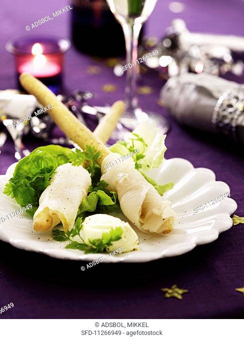 Halibut rolls on a bed of lettuce with cream cheese