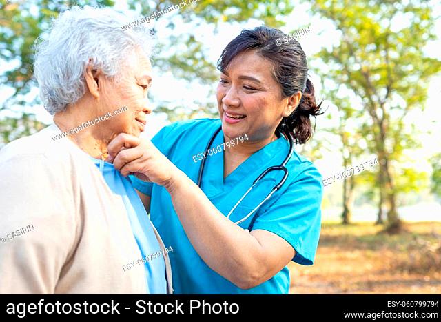 Doctor help and care Asian senior or elderly old lady woman walking at park in happy fresh holiday